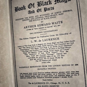 May include: A vintage book cover with the title "The Book of Black Magic and of Pacts" by Arthur Edward Waite. The book includes illustrations and is a reprint of the 1898 London edition.