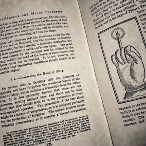 May include: A black and white illustration of a hand holding a lit candle. The hand is depicted with a clenched fist, and the candle is held upright between the thumb and index finger. The image is from an old book and has a vintage aesthetic.
