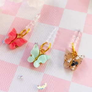 Tapón antipolvo con forma de mariposa, bonito colgante de mariposa nacarada de primavera, tapón antipolvo para el conector de audio de los auriculares del mando de juegos Switch