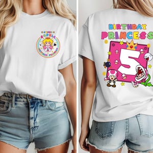 May include: White t-shirt with a pink and white graphic of a princess character and the text "Super Sophia Birthday Princess". The back of the shirt has a pink and white graphic of a number 5 with a crown and other characters from the video game.