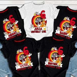 May include: Set of five black and white t-shirts with a cartoon cat and mouse design. The shirts feature the text "Mommy of the Birthday Girl", "Daddy of the Birthday Girl", "Sister of the Birthday Girl", "Brother of the Birthday Girl", and "Julia Birthday Girl".