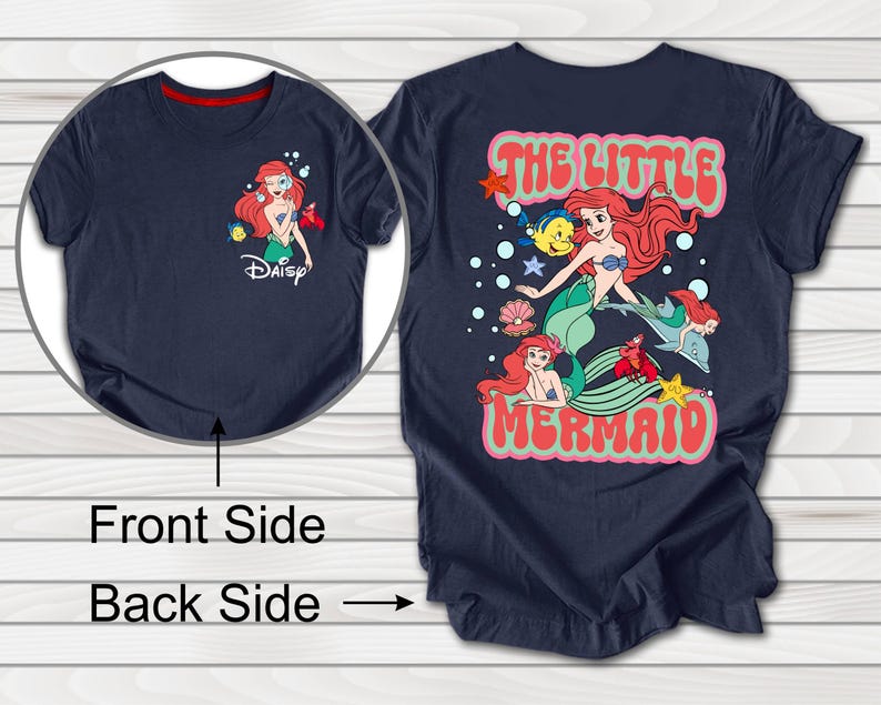 May include: Navy blue t-shirt featuring a front graphic of Ariel from Disney's The Little Mermaid, with the Disney logo. The back of the shirt displays a larger graphic with the text "The Little Mermaid" and Ariel with other characters.