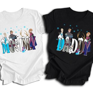 May include: Two t-shirts, one white and one black, featuring characters from the movie Frozen. The white shirt says "Mommy" and the black shirt says "Daddy", both in a stylized font with cartoon images of the characters.
