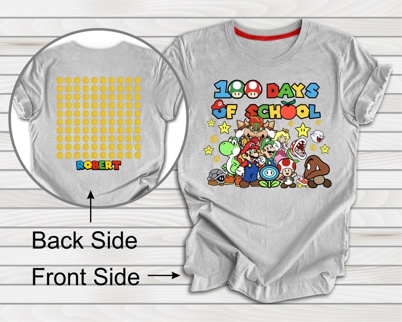 Puede incluir: Camiseta gris con un dise&ntilde;o de Mario que dice "100 d&iacute;as de escuela". La parte posterior de la camiseta tiene una cuadr&iacute;cula de 100 monedas de oro con el nombre "ROBERT" impreso debajo.