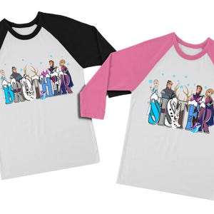 May include: Two white raglan shirts with cartoon characters and text. One shirt has black sleeves and the word "Brother" in blue and white letters. The other shirt has pink sleeves and the word "Sister".