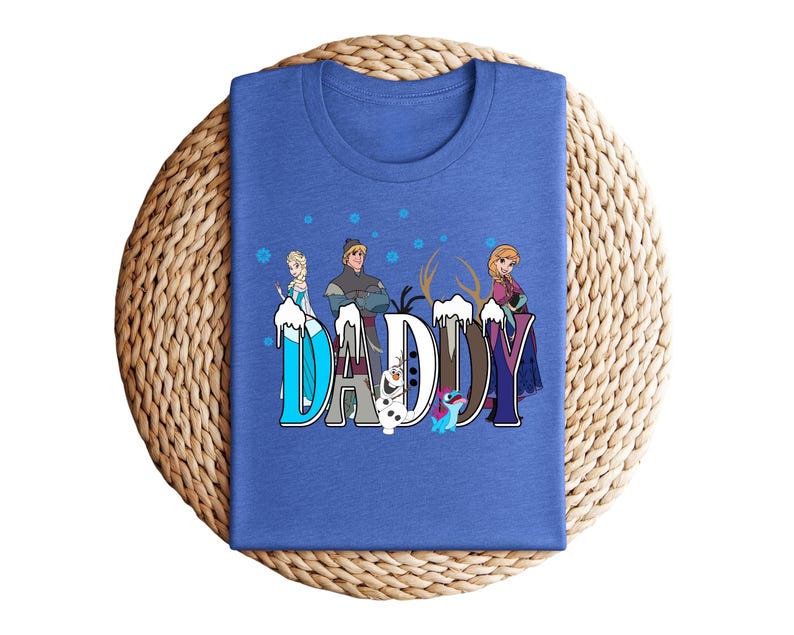 May include: A blue t-shirt featuring the word "DADDY" in a stylized font with characters from the movie Frozen. The design includes images of Elsa, Anna, Kristoff, and Olaf, with snowflakes and ice accents.