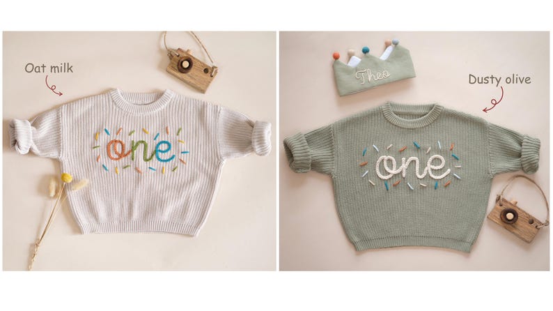 May include: Two knitted baby sweaters with the word "one" embroidered on them. The sweater on the left is oat milk colored and the sweater on the right is dusty olive colored.