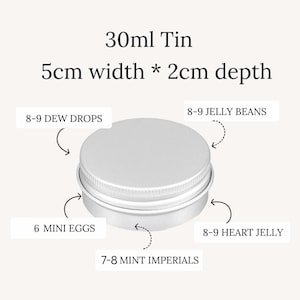 May include: A silver-colored 30ml tin with a 5cm width and 2cm depth. The image shows the tin's capacity for various candies, including 8-9 Dew Drops, 6 Mini Eggs, 8-9 Jelly Beans, 8-9 Heart Jelly, and 7-8 Mint Imperials.