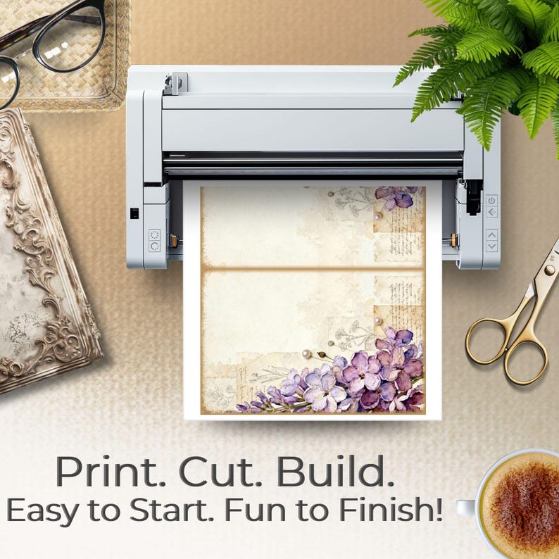 Hands hold an open journal featuring blue floral Whispered Blooms pages with layered blossoms and antique paper details. The soft wooden background and floral styling emphasize tactile creativity. Text reads “Glow Up Your Craft Stash,” suggesting use for junk journaling, memory keeping, and decorative paper crafting.