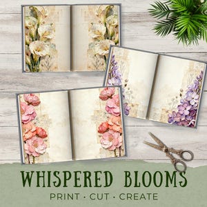 Styled mockup of Whispered Blooms junk journal pages displayed on a light wood surface. One open book features creamy white florals with pearl details, while another shows lavender flowers layered over vintage paper textures. Decorative scissors and greenery add a cozy craft-table setting, emphasizing printable journaling and paper crafting use.