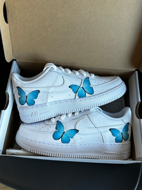 white nike with blue butterfly