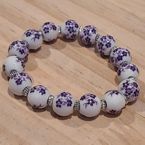 Purple and white floral ceramic bracelet.
