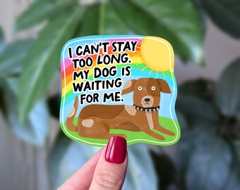 May include: A colourful sticker depicting a brown dog on green grass, with a yellow sun and rainbow. The text on the sticker reads: "I CAN'T STAY TOO LONG. MY DOG IS WAITING FOR ME."