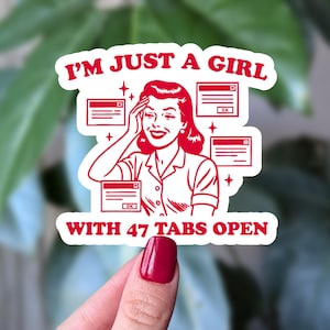 May include: A red and white sticker with the text "I'M JUST A GIRL WITH 47 TABS OPEN." The sticker features a retro illustration of a woman with multiple open windows.