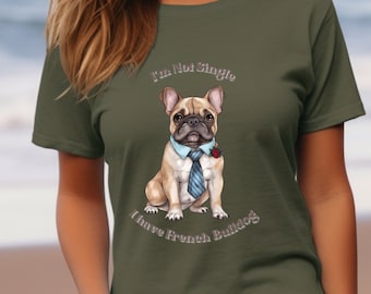 May include: A woman wearing a green t-shirt with a French Bulldog wearing a blue tie and a red rose. The text on the shirt reads "I'm Not Single I Have French Bulldogs".