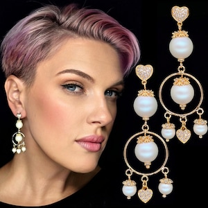 Long gold bridal statement chandelier dangle earrings with white iridescent pearls and cubic zirconia hearts