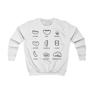 May include: White sweatshirt with a black and white climbing hold diagram. The diagram includes labels such as 'crimp', 'jug', and 'mono'. The sweatshirt has a crew neck and long sleeves. The design is centered on the chest.