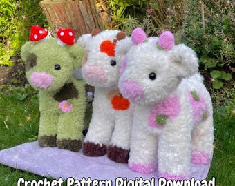 May include: Three crocheted cow plushies in different colors and patterns. The cow on the left is green with brown spots and pink accents. The middle cow is white with orange and brown spots. The cow on the right is white with pink and green spots. The plushies are sitting on a purple towel. The text "Cow Pattern + Mod Bundle" is at the top of the image. The text "Crochet Pattern Digital Download NO Physical Product" is at the bottom of the image.