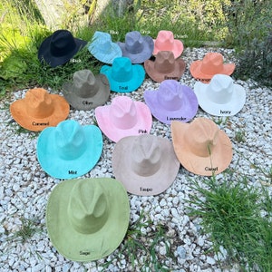 May include: A collection of 14 cowboy hats in various colors, including black, blue, grey, peach, brown, orange, teal, ivory, lavender, pink, mint, taupe, sage, and camel.