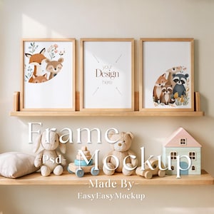 May include: Three wooden picture frames with white mats and illustrations of animals, including a fox, raccoon, and deer. The frames are on a wooden shelf with a teddy bear, a toy house, and a toy car.