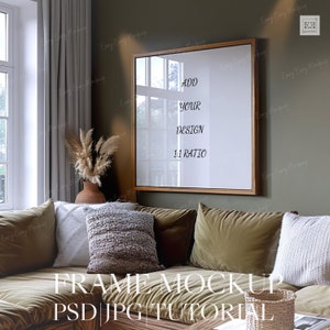 May include: A brown wooden frame with a white mat and a white background. The frame is hanging on a green wall in a living room setting. The text "ADD YOUR DESIGN 1:1 RATIO" is visible in the frame.