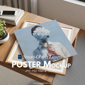 May include: A poster mockup featuring a framed print with a painting of a person holding a blue flower. The poster is layered on a wooden table with a stack of books and a small plant. The text "POSTER Mockup" is visible.
