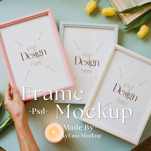 May include: Three picture frames with white mounts and different coloured frames. The frames are on a light blue surface with yellow flowers and a lit candle. The text "your design here" is in each frame.