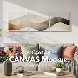 May include: A three-panel canvas art piece with abstract wave designs in neutral tones of beige, brown, and gray hangs above a beige sofa. The sofa is adorned with colorful pillows. A coffee table displays a mug, books, and a plant.