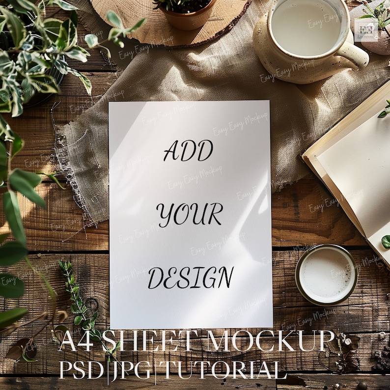 May include: A white sheet of paper with the text "ADD YOUR DESIGN" on a wooden table with plants and a cup of coffee. The text "A4 SHEET MOCKUP PSD JPG TUTORIAL" is below the paper.