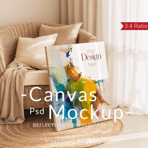 May include: A canvas mockup with a colorful abstract painting of a seated figure. The canvas is propped up against a wicker chair with pillows and a blanket. The text "your Design here" is visible on the canvas. The words "-Canvas Psd Mockup-" are also visible.