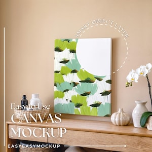 May include: A canvas mockup featuring a floral design in shades of green and white. The canvas is displayed on a wooden surface, with decorative vases and an orchid plant. Text on the image reads "Easy to Use CANVAS MOCKUP".