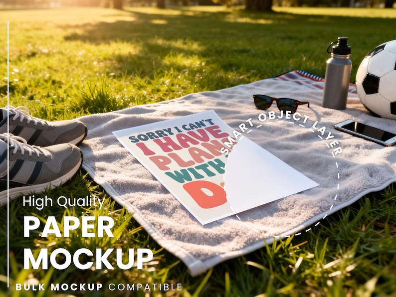 May include: A picnic scene with a soccer ball, sunglasses, a water bottle, and a smartphone on a towel. A paper mockup with the text "SORRY I CAN'T I HAVE PLANS WITH D" is displayed. Sneakers are in the foreground.