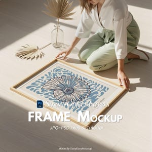 May include: A framed art print featuring a seashell design in shades of blue and white. The frame is light-colored wood. The image also includes text that reads "FRAME Mockup" and "Smart Object Layers".