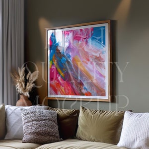 May include: A framed abstract painting with a wooden frame. The painting features a colorful abstract design with shades of pink, blue, yellow, and red.