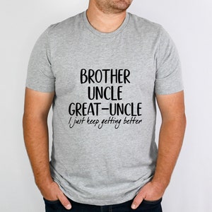 May include: A gray t-shirt with black text that reads "Brother Uncle Great-Uncle I just keep getting better".