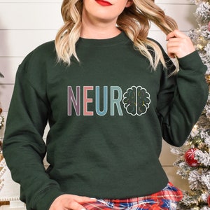 a woman standing next to a christmas tree