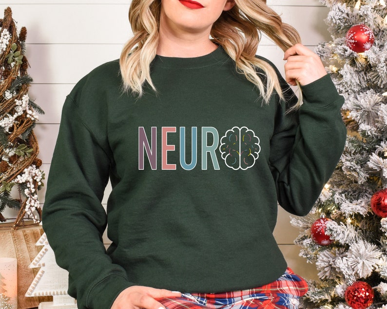 a woman standing next to a christmas tree