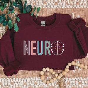 a red sweatshirt with the word neuro on it