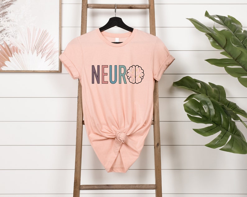 a t - shirt that says neuroo is hanging on a ladder