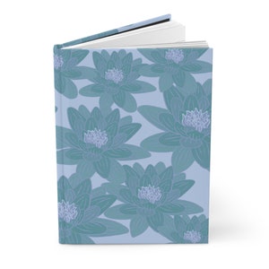May include: A blue notebook with a floral design featuring blue water lilies on a light blue background.