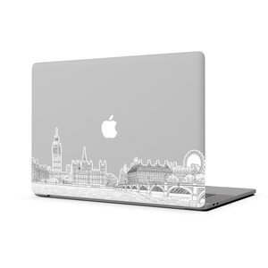 K&ouml;nnte beinhalten: Ein silberner Laptop mit einer Schwarzwei&szlig;-Zeichnung der Londoner Skyline auf dem Deckel. Die Zeichnung zeigt Big Ben, das London Eye und das Houses of Parliament.