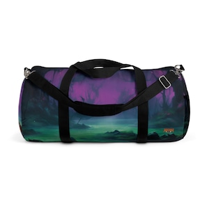 May include: A black duffel bag with a purple and green landscape design. The bag has a black zipper and a black strap.