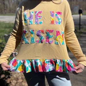 Upcycled Floral Christian Sweatshirt: Split Ruffle Hem “He Is Risen” Graphic