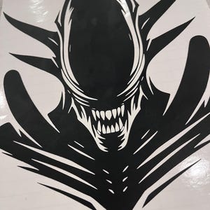 May include: Black and white silhouette of an alien creature with a sharp, toothy mouth. The alien has a large head and a long, thin body. The creature is depicted in a menacing pose.