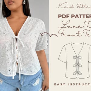 May include: A white eyelet Luna Tie Front Tee with a V-neck and tie closure. The shirt has short sleeves and a paisley pattern. The image also includes the text "Kind Patterns PDF Pattern Luna Tie Front Tee" and a line drawing of the shirt.
