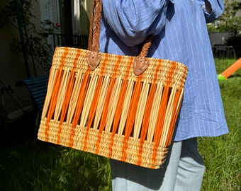 Two-tone orange "Meknes" basket, woven in straw and wicker with leather handles