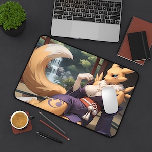 May include: A yellow and orange fox-like creature with a long tail, wearing a purple and red kimono, sits on a yellow and green patterned mouse mat. The creature has a white and yellow fur pattern and a black eye with a yellow pupil. The mouse mat has a waterfall and a wooden structure in the background.