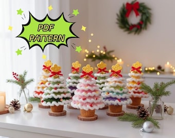 May include: A collection of colorful, crocheted Christmas trees with a variety of colors, including white, green, pink, and yellow. Each tree has a star topper and sits on a wooden base. The image includes the text "PDF PATTERN".