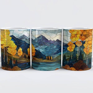 May include: Three white ceramic mugs with a stained glass design. The design features a mountain landscape with a lake and yellow trees.