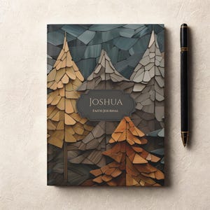May include: A rectangular faith journal with a cover featuring a mosaic-style forest of pine trees in shades of gold, brown, and gray. A dark gray label in the center displays the text JOSHUA FAITH JOURNAL. A black pen is positioned to the right.